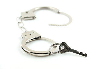 the key of the house in handcuffs, isolated on white background
