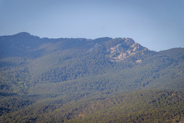 Russian mountains. Crimea. Summer mountains background. Forest and mountains in the sun on the background of a cloudy sky above the peninsula of Crimea. Sunny, bright, saturated raster photo