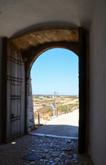 Fototapeta premium Looking Through an Arch Out to Blue Sky