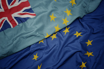 waving colorful flag of european union and flag of Tuvalu.