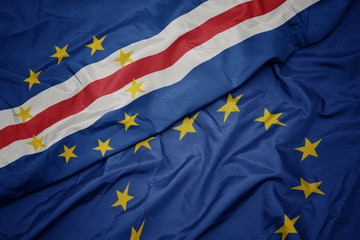 waving colorful flag of european union and flag of cape verde.