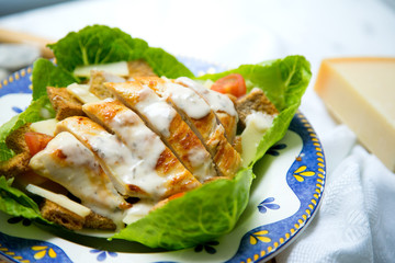 Chicken dish from a restaurant. Cesar Salad.