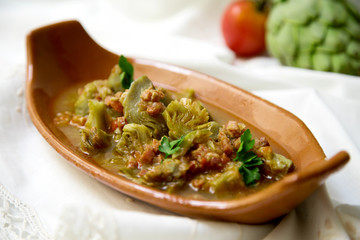 Arichokes with ham. Spanish traditional tapa.