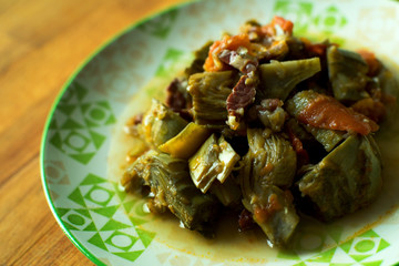 Arichokes with ham. Spanish traditional tapa.