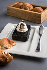 Round Buns on the White plate with spatula for butter. Creative serving dishes top view