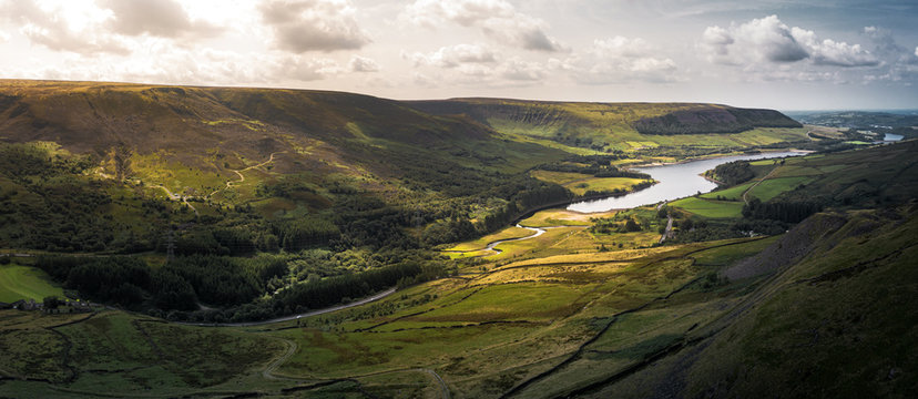 Stunning aerial panoramic shot of the Peak District National Park at the Woodhead to Torside reservoirs showing the streams of water connecting the two