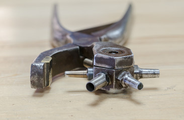 Leather Hole Punch Tool , antique on wooden background, close up
