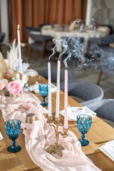 Candles in the foreground. Luxury dinner Banquet in the restaurant. Beautiful and exquisite decoration of the wedding celebration.