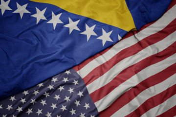 Obraz premium waving colorful flag of united states of america and national flag of bosnia and herzegovina.