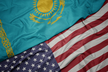 waving colorful flag of united states of america and national flag of kazakhstan. macro