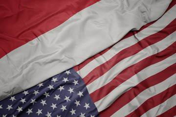 Obraz premium waving colorful flag of united states of america and national flag of indonesia.