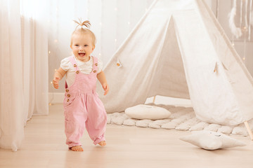 baby girl playing in the nursery, baby learning to walk, textiles for the nursery., tent in the children's room