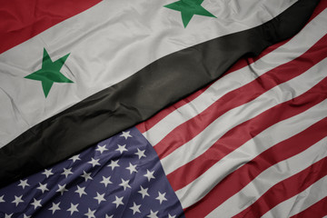 waving colorful flag of united states of america and national flag of syria.