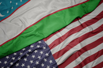 waving colorful flag of united states of america and national flag of uzbekistan.