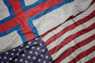 waving colorful flag of united states of america and national flag of faroe islands.