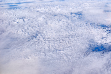 Blue sky above the clouds from airplane window