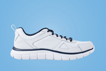 One male white sneakers on a blue background. Sport shoe close up