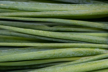 Green onion counter in a shop, green onions in a supermarket.