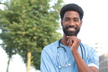 Beautiful happy doctor outside in the park