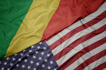 waving colorful flag of united states of america and national flag of republic of the congo.