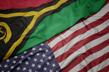 waving colorful flag of united states of america and national flag of Vanuatu.