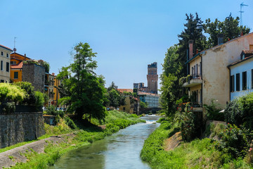 Fototapeta na wymiar Padova, Italy - Jujy, 4, 2019: embankment of a channel in Padova, Italy
