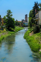 Fototapeta na wymiar Padova, Italy - Jujy, 4, 2019: embankment of a channel in Padova, Italy