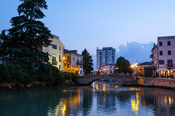 Adria, Italy - July, 07, 2019: cityscape with the image of channel in Adria, Italy in the evening
