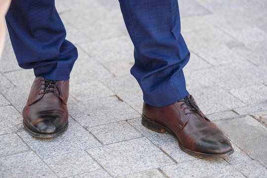 the image of the feet of a man in shoes