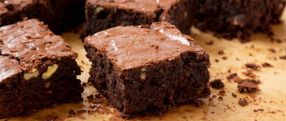 Home-baked chocolate brownies on a baking sheet, side view. Closeup.