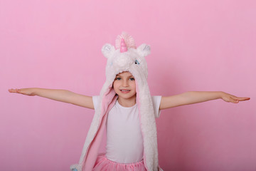 caucasian beautiful little girl in a hat with a unikorn
