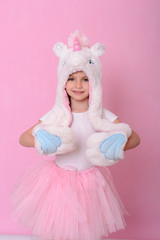 caucasian beautiful little girl in a hat with  unikorn
