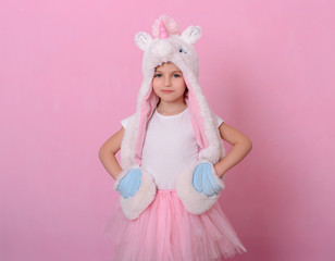 caucasian beautiful little girl in a hat with  unikorn