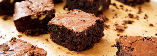 Home-baked chocolate brownies on a baking sheet, side view. Close-up.