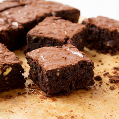Home-baked chocolate brownies on a baking sheet, side view. Closeup.
