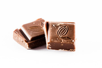 Ounces of chopped sweet chocolate, chocolate bars on a white background.