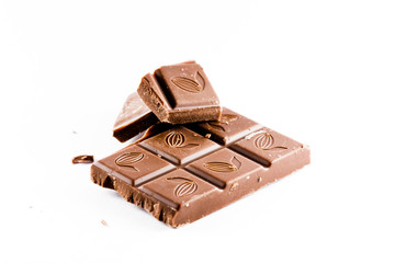 Ounces of chopped sweet chocolate, chocolate bars on a white background.