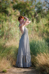FREEDOM, WOMAN STANDING ARMS IN THE AIR OUTSIDE.