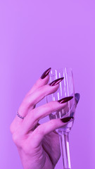 hand with glass of red wine