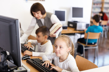 Preteen girl studying in computer class
