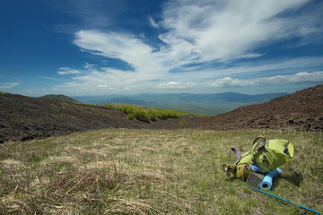 Green Backpack In Mountain Landscape