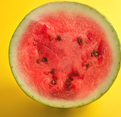 half round ripe red watermelon with brown seeds
