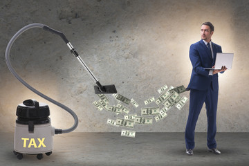 Businessman and vacuum cleaner sucking money out of him