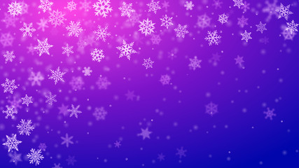Christmas background of complex blurred and clear falling snowflakes in blue and purple colors with bokeh effect
