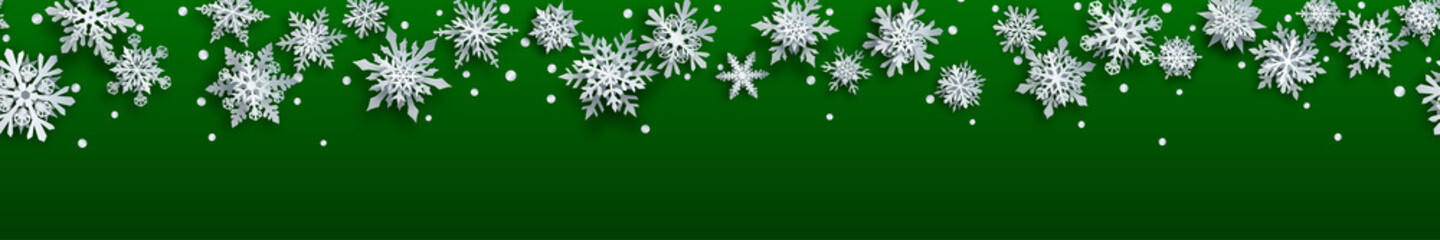 Christmas banner of white complex paper snowflakes with soft shadows on green background. With horizontal repetition