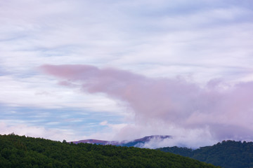 overcast purple sky above the mountain ridge at dawn. beautiful nature background