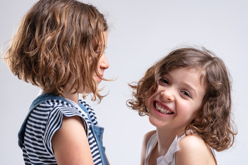 Happy friendly attractive young girl with sister