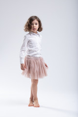 Little girl in pink ballet tutu or filmy skirt
