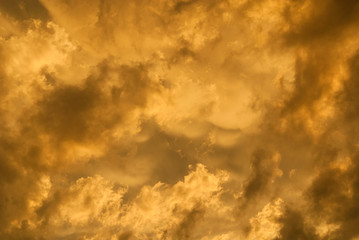 Wonderful sunset sky with golden clouds as background