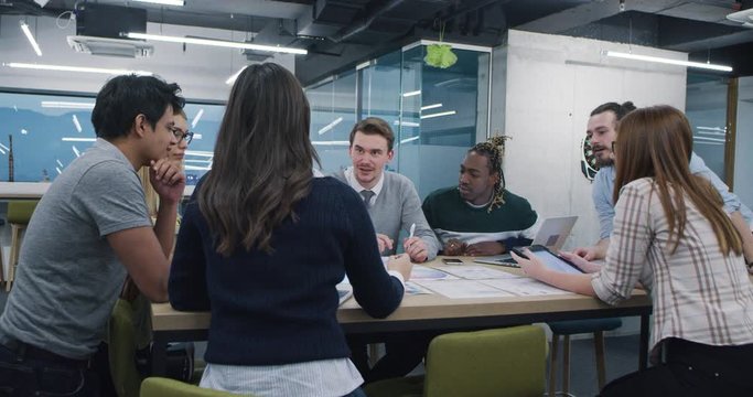 Young multiethnic business team of software developers working together using